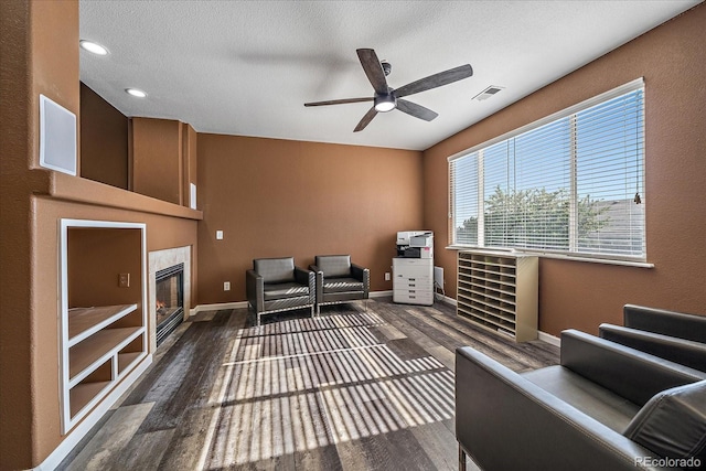 2404 S Genoa Way, Aurora, CO 80013 - sitting room with wood finished floors, ceiling fan, baseboards, recessed lighting, and a glass covered fireplace