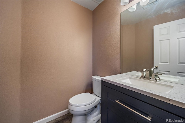 2404 S Genoa Way, Aurora, CO 80013 - bathroom featuring vanity, toilet, and a textured wall