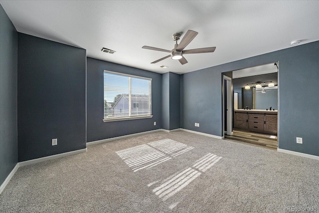 2404 S Genoa Way, Aurora, CO 80013 - unfurnished bedroom featuring carpet floors, baseboards, ensuite bathroom, and a ceiling fan