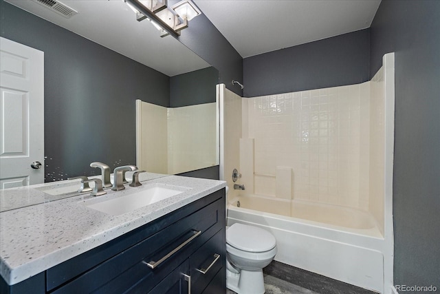 2404 S Genoa Way, Aurora, CO 80013 - bathroom featuring toilet, vanity, and  shower combination