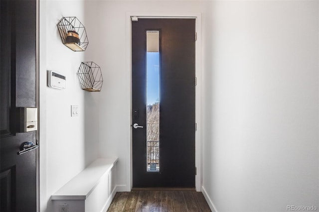 interior space with dark wood-style flooring and baseboards