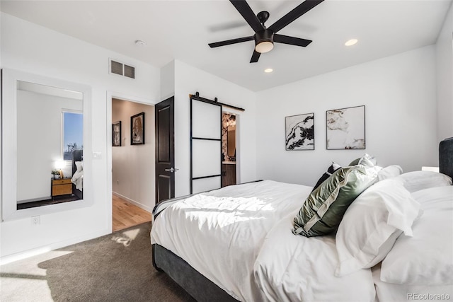 bedroom featuring baseboards, visible vents, carpet, recessed lighting, and a barn door