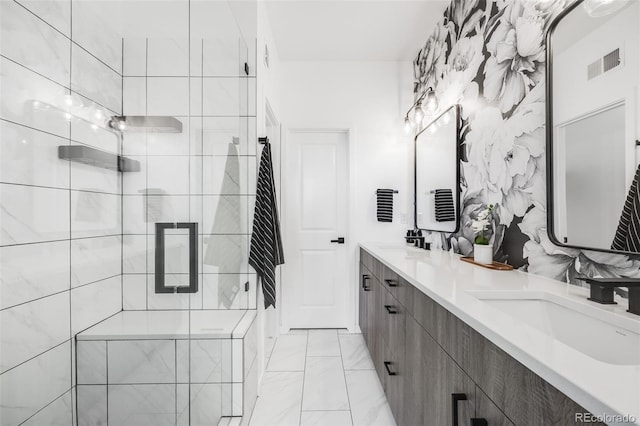 full bathroom with visible vents, double vanity, marble finish floor, a stall shower, and a sink