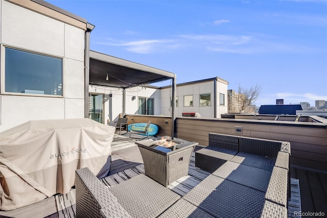 view of patio with an outdoor living space with a fire pit