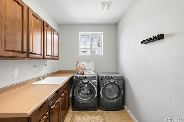 17378 W 78th Dr, Arvada, CO 80007 - laundry area featuring washing machine and clothes dryer, light tile patterned floors, cabinet space, and baseboards