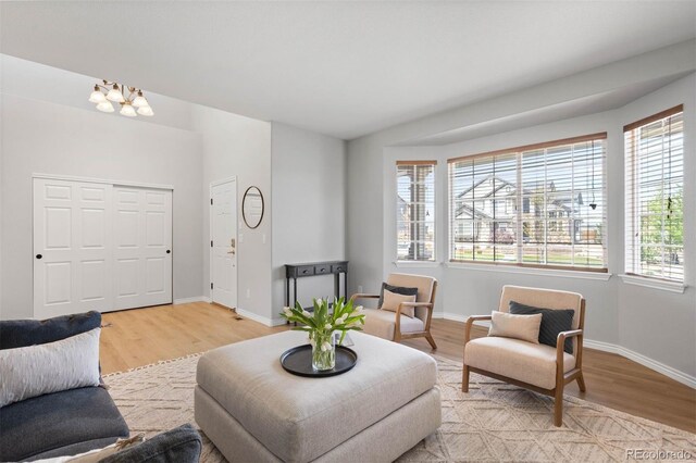 17378 W 78th Dr, Arvada, CO 80007 - living room featuring light wood-style flooring, plenty of natural light, and a chandelier