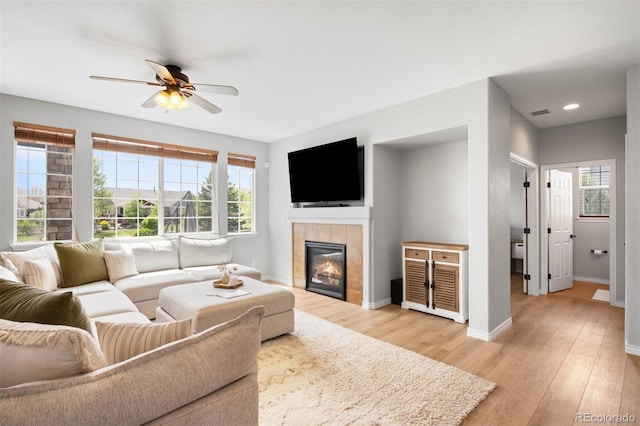 17378 W 78th Dr, Arvada, CO 80007 - living area with a fireplace, light wood-type flooring, baseboards, ceiling fan, and recessed lighting