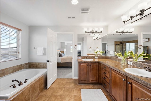 17378 W 78th Dr, Arvada, CO 80007 - ensuite bathroom with double vanity, a garden tub, a chandelier, tile patterned floors, and an enclosed shower