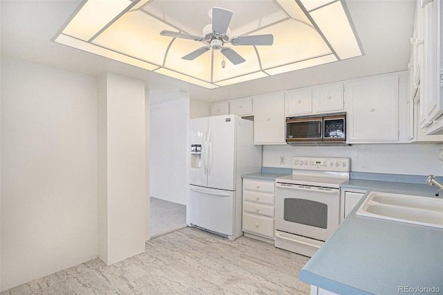 13800 E Marina Dr Unit 601, Aurora, CO 80014 - kitchen with white appliances, ceiling fan, white cabinetry, and light countertops
