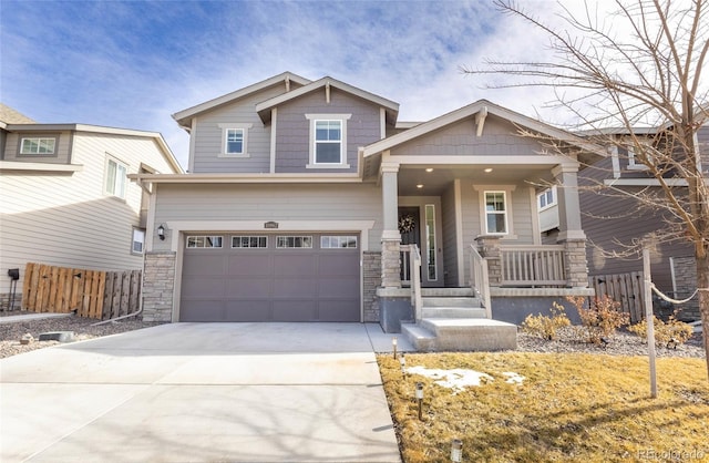 craftsman-style house with stone siding, driveway, an attached garage, and fence