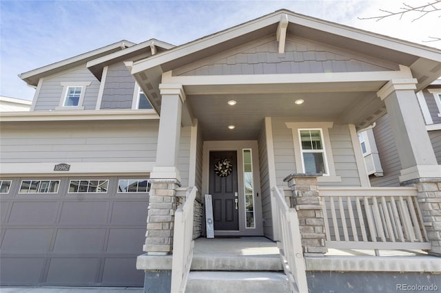 entrance to property with a garage and stone siding