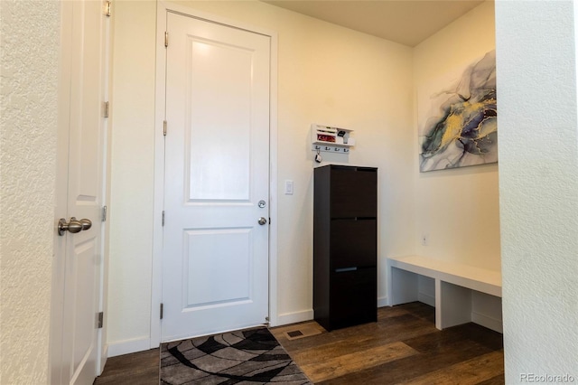 interior space with dark wood-style flooring and baseboards