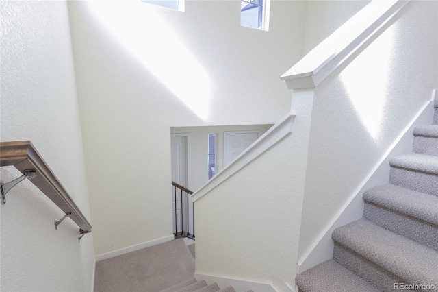 staircase with carpet floors and baseboards