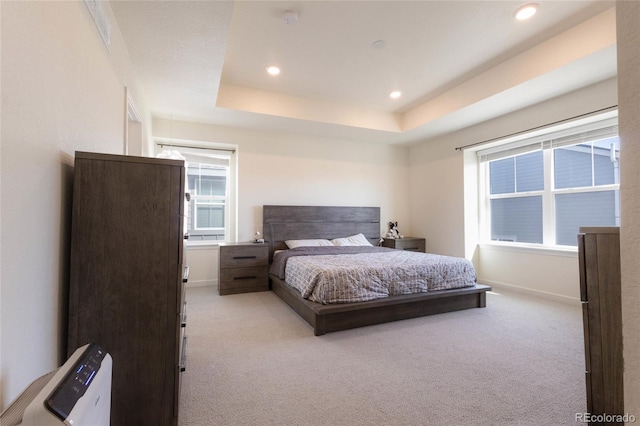 bedroom with baseboards, a tray ceiling, recessed lighting, and light colored carpet