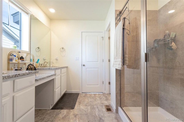 full bathroom with visible vents, a shower stall, and vanity