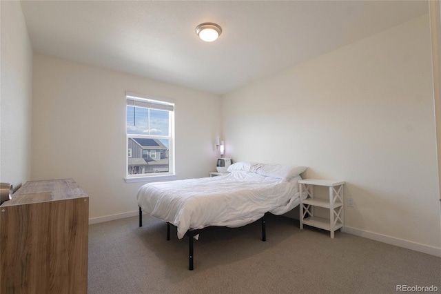 bedroom with light carpet and baseboards