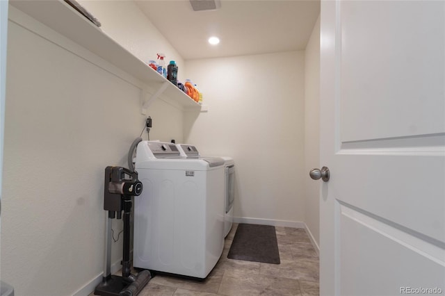 laundry area with laundry area, visible vents, baseboards, and separate washer and dryer