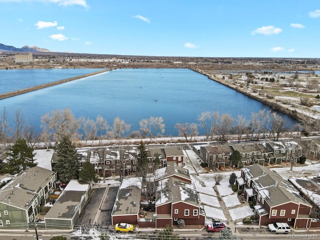 snowy aerial view featuring a water view