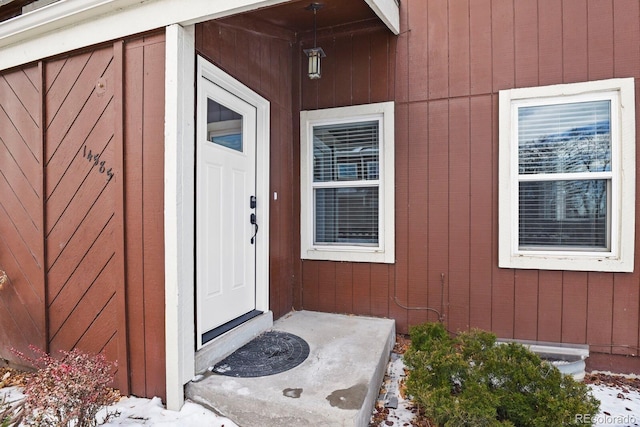 view of snow covered property entrance