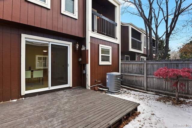 snow covered deck featuring central AC unit