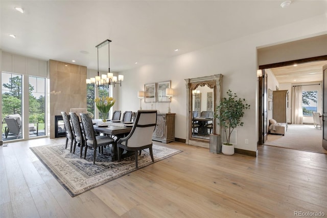 dining area featuring a notable chandelier and light hardwood / wood-style flooring