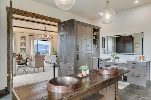 dining area featuring dark carpet, a chandelier, and wooden ceiling