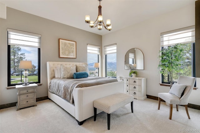 bedroom with light colored carpet and an inviting chandelier