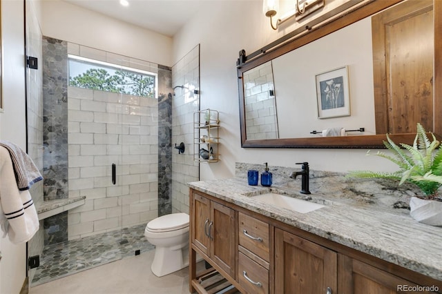 bathroom with toilet, an enclosed shower, vanity, and tile patterned floors