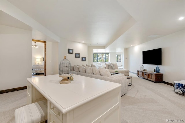 carpeted living room with an inviting chandelier