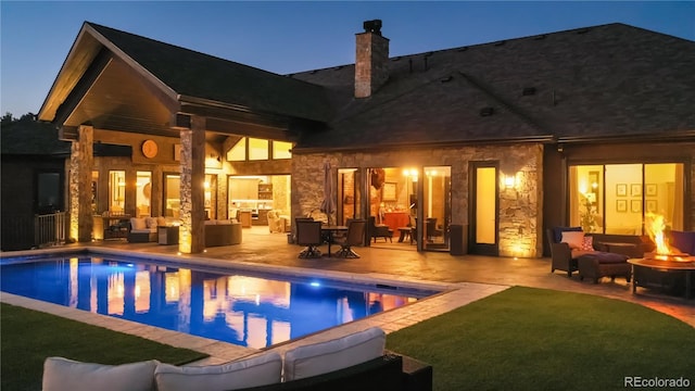 rear view of house with a patio, a yard, and outdoor lounge area