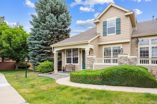 10166 Grove Loop Unit D, Westminster, CO 80031 - view of front of home with a front lawn, roof with shingles, and stone siding