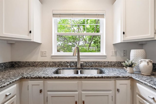 10166 Grove Loop Unit D, Westminster, CO 80031 - kitchen with a sink, white cabinetry, and dark stone counters