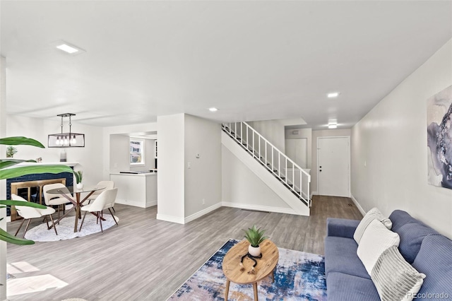 living room featuring light hardwood / wood-style flooring and a chandelier