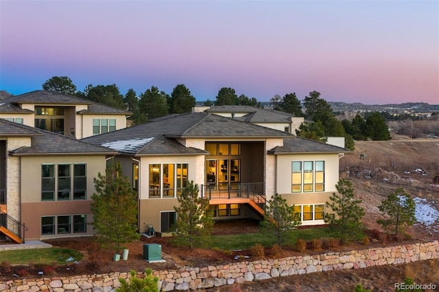 view of back house at dusk