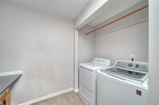 washroom featuring independent washer and dryer and light carpet