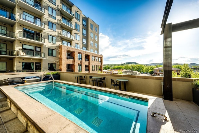 view of swimming pool with a mountain view