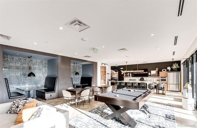 rec room featuring light tile patterned flooring, bar, a fireplace, and pool table