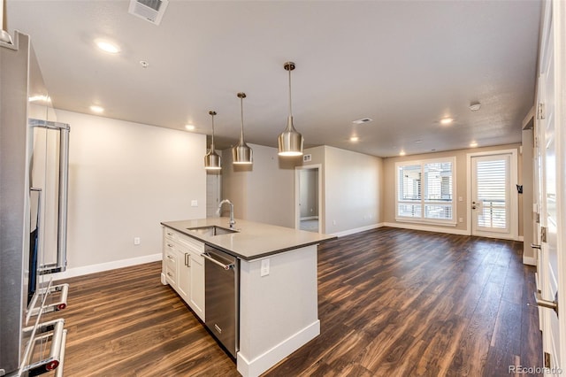 kitchen featuring dishwasher, dark wood-type flooring, sink, decorative light fixtures, and white cabinetry