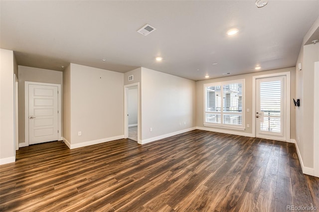 unfurnished room featuring dark wood-type flooring