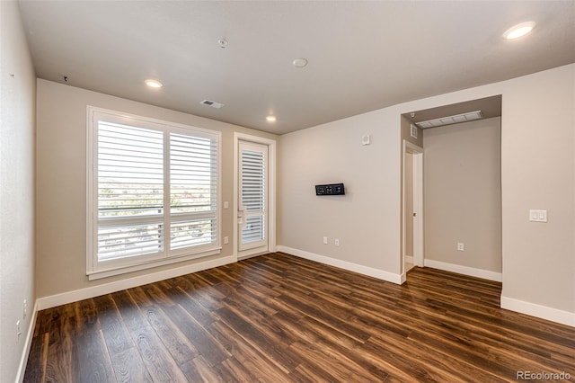 spare room with dark hardwood / wood-style flooring