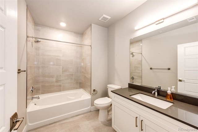 full bathroom featuring tile patterned flooring, vanity, tiled shower / bath combo, and toilet