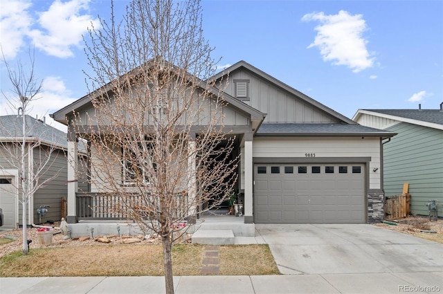 9883 Truckee St, Commerce City, CO 80022 - view of front of house featuring board and batten siding, an attached garage, and concrete driveway