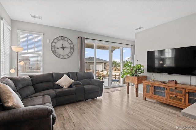 9883 Truckee St, Commerce City, CO 80022 - living area with light wood-style flooring and visible vents