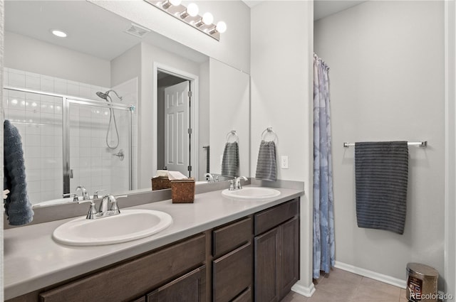 9883 Truckee St, Commerce City, CO 80022 - bathroom featuring a sink, visible vents, a shower stall, and tile patterned flooring