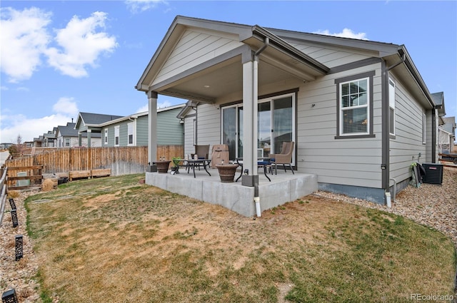 9883 Truckee St, Commerce City, CO 80022 - rear view of house with a patio, a yard, and fence