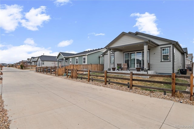 9883 Truckee St, Commerce City, CO 80022 - view of front of home with covered porch, a residential view, and a fenced front yard