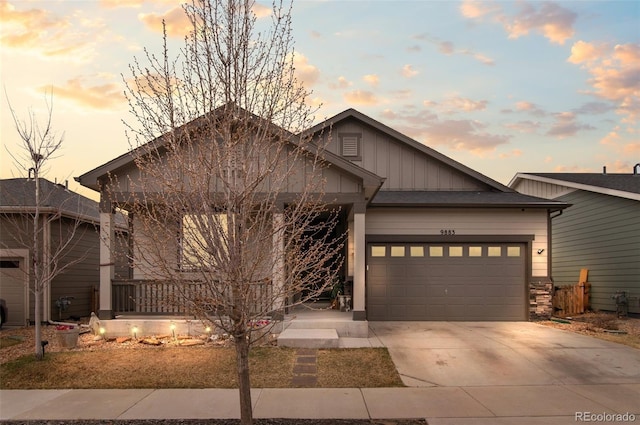9883 Truckee St, Commerce City, CO 80022 - view of front of property featuring board and batten siding, an attached garage, and driveway