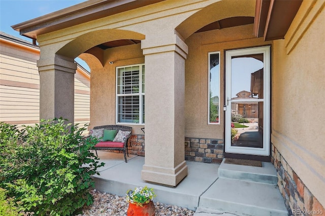 8582 E 148th Ln, Thornton, CO 80602 - doorway to property featuring stucco siding and stone siding