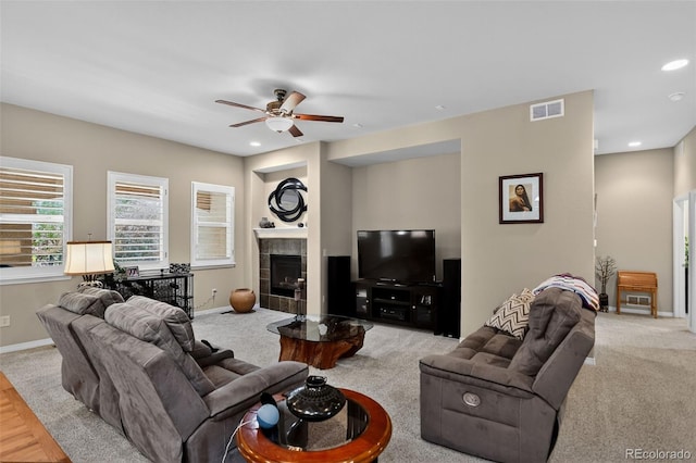 8582 E 148th Ln, Thornton, CO 80602 - living area with a ceiling fan, a tiled fireplace, recessed lighting, and carpet flooring