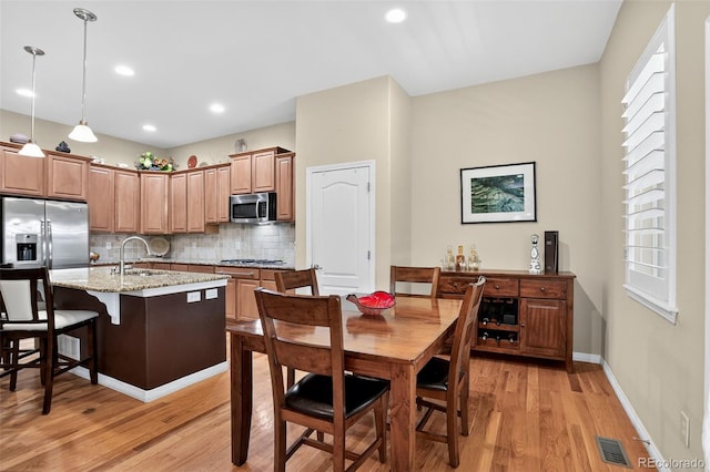 8582 E 148th Ln, Thornton, CO 80602 - dining area with light wood-type flooring and recessed lighting